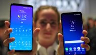 A hostess holds two new Samsung Galaxy S9 mobilephones during the Samsung Galaxy S9 Unpacked event on February 25, 2018 in Barcelona, on the eve of the inauguration of the Mobile World Congress (MWC). (AFP / LLUIS GENE)