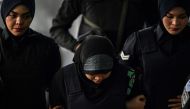Indonesian national Siti Aisyah (C) is escorted by Malaysian police for another appearance at court for her trial at the Shah Alam High Court in Shah Alam, outside Kuala Lumpur on February 22, 2018 for her alleged role in the assassination of Kim Jong-Nam