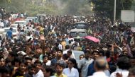 Indian fans gather outside the house of the late Bollywood actress Sridevi Kapoor ahead of her funeral in Mumbai on February 28, 2018. / AFP / PUNIT PARANJPE 