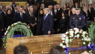 President Donald Trump and first lady Melania Trump participate in a ceremony in the U.S. Capitol Rotunda to honor Christian evangelist and Southern Baptist minister Billy Graham February 28, 2018 in Washington, DC.  Chip Somodevilla/Getty Images/AFP