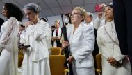 A woman holds her AR-15-style rifle as people attend a blessing ceremony with their AR-15-style rifles in their cases at the Sanctuary Church in Newfoundland, Pennsylvania, U.S., February 28, 2018. Reuters/Eduardo Munoz