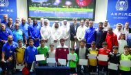 Students and Aspire Academy officials pose for a photograph during the awards ceremony of the Goalkeeper External Potential Programme.