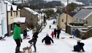 The main high street in the village of St Florence is used as a sledging slope after Storm Emma and heavy snowfall hit the area, in West Wales March 2, 2018. Reuters/Rebecca Naden