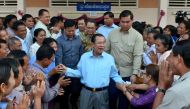 File photo of  Cambodia's Prime Minister Hun Sen (C) greeting commune councillors at a polling station in Kandal province on February 25, 2018. / AFP / Khem SOVANNARA 