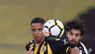 Qatar SC and Umm Salal players vie for ball possession during their QSL game yesterday.   