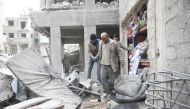 Abu Mohammad Alaya, 50, is helped after getting out from shelter in Douma, Syria February 22, 2018. REUTERS/Bassam Khabieh
