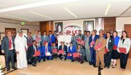 QIC officials with the employees during the event.