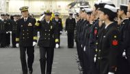 Newly-appointed Commander of First Escort Division of Japan Maritime Self-Defense Force (JMSDF) Ryoko Azuma (2nd L), who is the first female commander of a navy destroyer squadron in Japan, salutes to soldiers on JMSDF's helicopter carrier Izumo at a port