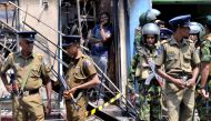 Sri Lanka's Special Task Force and Police officers stand guard near a burnt house after a clash between two communities in Digana, central district of Kandy, Sri Lanka March 6, 2018. REUTERS/Stringer 