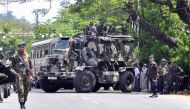 Sri Lankan police commandos patrol on the streets of Pallekele, a suburb of Kandy, on March 6, 2018, following anti-Muslim riots that has prompted the government to declare a state of emergency. AFP