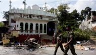 Sri Lanka's Special Task Force soldiers walk past a damaged mosque after a clash between two communities in Digana central district of Kandy, Sri Lanka March 8, 2018. REUTERS/Dinuka Liyanawatte
