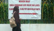 This photo taken on March 7, 2018 shows a student wearing a niqab face veil outside a university in Yogyakarta.  AFP / Agus WARDOYO
