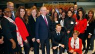 French President Emmanuel Macron (2ndR) and French Junior Minister for Gender Equality Marlene Schiappa (2ndL) pose with employees of an investment company where women and men are paid the same for the same work, on March 8, 2018 in Paris. AFP / Michel Eu