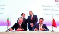 The Minister of Economy and Commerce H E Sheikh Ahmed bin Jassim Al Thani (standing right), and his Bulgarian counterpart Emil Karanikolov (standing left) witnessing the signing ceremony of an agreement signed by Sheikh Khalifa bin Jassim Al Thani (sittin