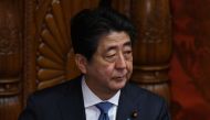 Japanese Prime Minister Shinzo Abe looks at upper house members at parliament in Tokyo on March 9, 2018.  / AFP / Toru YAMANAKA 
