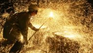 In this file photo taken on April 12, 2006 an iron and steel worker makes a test on a casting at Ascometal factory in Fos-sur-Mer, south-eastern France (AFP / Boris Horvat) 