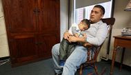 Business owner Oscar Canales holds his son, George, as he speaks during an interview at the Congregational United Church of Christ where he is living in sanctuary on February 12, 2018, in Greensboro, North Carolina. 
AFP / Issam Ahmed 