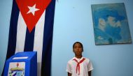 (FILES) In this file photo taken on November 26, 2017 a schoolboy remains standing at a polling station at Nautico neighbourhood in Havana during municipal elections. AFP / YAMIL LAGE