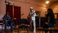 Zimbabwe music icon Oliver 'Tuku' Mtukudzi plays his guitar during a rehearsal with a group of young musicians who are incubated at his Pakare Paye Arts and Music Centre in Norton 45km from the country's capital city Harare on January 12, 2018. / AFP / Je