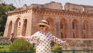 Former US politician Hillary Clinton gestures outside the remains of the Hindola Mahal monument, part of an abandoned royal palace complex, while on a personal trip to the ancient city of Mandu in India's Madhya Pradesh state on March 12, 2018. / AFP
