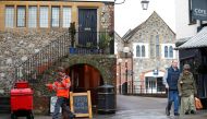 A Royal Mail postal workers delivers mail in Salisbury, southern England, on March 12, 2018, near to where a man and woman were found critically ill on March 4, after being apparently poisoned with what was later identified as a nerve agent sparking a maj