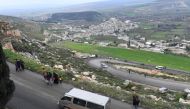 Civilians fleeing the city of Afrin in northern Syria walk at the mountainous road of al-Ahlam while heading towards the check point in az-Ziyarah, in the government-controlled part of the northern Aleppo province, on March 15, 2018 on the way to seek ref