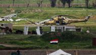 FILE PHOTO: An Iraqi army helicopter sits in a field on the outskirts of western Mosul on April 3, 2017 during an offensive to retake the city from Islamic State group fighters. (AFP / Ahmad Gharabli) 