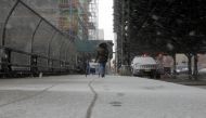 A pedestrian walks through a late season snow storm in New York, U.S., March 21, 2018. REUTERS/Lucas Jackson