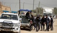 Hamas police mobilize in the street in Nuseirat, south of Gaza City on March 22, 2018, as they carry out a raid that resulted in the arrest of a suspect in a recent bomb attack against the Palestinian prime minister, officials said. (AFP / MAHMUD HAMS)