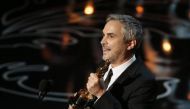 Alfonso Cuaron accepts the Oscar for best director for 