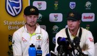 This video grab taken from a footage released by AFP TV shows Australia's captain Steve Smith (R), flanked by teammate Cameron Bancroft, speaking during a press conference in Cape Town, on March 24, 2018 as he admitted to ball-tampering during the third T