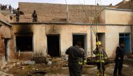 Afghan security personnel inspect the site after two suicide bombers struck a mosque in Herat on March 25, 2018. / AFP / HOSHANG HASHIMI 