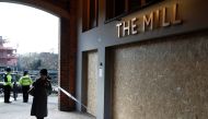 Police officers stand by the Mill pub as inspectors from the Organisation for the Prohibition of Chemical Weapons (OPCW) arrive to begin work at the scene of the nerve agent attack on former Russian agent Sergei Skripal, in Salisbury, Britain March 21, 20