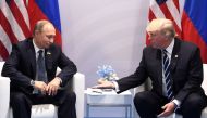 (FILES) In this file photo taken on July 7, 2017 US President Donald Trump and Russia's President Vladimir Putin shake hands during a meeting on the sidelines of the G20 Summit in Hamburg, Germany. AFP / SAUL LOEB