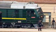 Police officers keep watch next to a train at the Beijing Railway Station in Beijing, China March 27, 2018. REUTERS/Jason Lee
