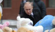Russian President Vladimir Putin lays a flower at the shopping mall in Kemerovo where over 64 people were killed on March 25, in Kemerovo, Russia on March 27, 2018. Anadolu
