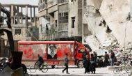 Syrians walk in the streets as they wait to be evacuated from Arbin in eastern Ghouta on March 27, 2018 after the rebel Islamist faction Faylaq al-Rahman reached a deal with Moscow, further emptying the onetime opposition bastion. AFP / Mohammed EYAD
