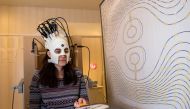 A woman is seen wearing a lightweight and highly sensitive brain imaging device in this undated handout photograph supplied by Wellcome and released in London, Britain March 22, 2018. Wellcome/Handout via REUTERS