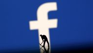 FILE PHOTO: A figurine is seen in front of the Facebook logo in this illustration taken, March 20, 2018. REUTERS/Dado Ruvic/Illustration/File Photo