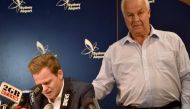 Cricketer Steve Smith (L) is comforted by his father Peter as he reacts at a press conference at the airport in Sydney on March 29, 2018, after returning from South Africa. AFP / PETER PARKS 