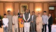Pakistani Prime Minister Shahid Khaqan Abbasi (C) posing for a photograph with Pakistani activist and Nobel Peace Prize laureate Malala Yousafza (4L) and her family at the Prime Minister Office during her visit to Islamabad. AFP 