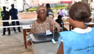 A woman casts a vote at a polling station in Freetown on March 31, 2018 during a country's general elections.  AFP / ISSOUF SANOGO
