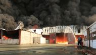 Firefighters try to extinguish a fire engulfing warehouse of the World Food Programme in Hodeida, Yemen March 31, 2018. REUTERS/Abduljabbar Zeyad
