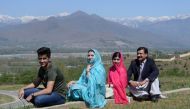 Pakistani activist and Nobel Peace Prize laureate Malala Yousafzai (2R), poses for a photograph along with her father Ziauddin Yousafzai (R), mother Torpekai (2L) and brother Atal Yousafzai (L) at the all-boys Swat Cadet College Guli Bagh, during her home
