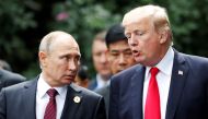 FILE PHOTO: U.S. President Donald Trump and Russia's President Vladimir Putin talk during the family photo session at the APEC Summit in Danang, Vietnam November 11, 2017. REUTERS/Jorge Silva/File Photo