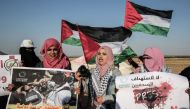 Palestinian Journalists take part in a protest against the killing of fellow journalist Yasser Murtaja, near the Israel-Gaza border, in Rafah in the southern Gaza Strip, on April 8, 2018.  AFP / Said Khatib