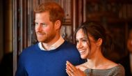 File photo of Britain's Prince Harry and his fiancee Meghan Markle watch a performance by a Welsh choir in the banqueting hall during a visit to Cardiff Castle in Cardiff, Britain, January 18, 2018. REUTERS/Ben Birchall/Pool/File Photo