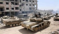A picture taken on April 8, 2018, shows Syrian Army soldiers gathering in an area on the eastern outskirts of Douma, as they continue their fierce offensive to retake the last opposition holdout in Eastern Ghouta.   AFP / STRINGER