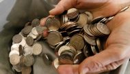A cashier places 5 rouble coins into a counting machine at an office in Krasnoyarsk, Russia, January 22, 2016. Reuters/Ilya Naymushin