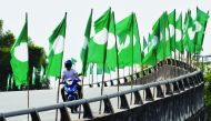 motorcyclist is seen between Parti Islam Se-Malaysia (Malaysian Islamic Party) flags in Bangi, Malaysia April 10, 2018. Reuters